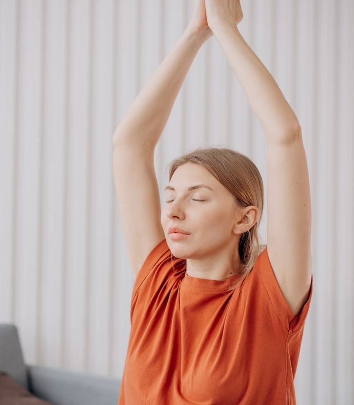 Person practicing mindful movement in a bright minimal room