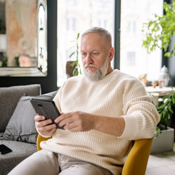 Serene person sitting in a calm position looking at the window